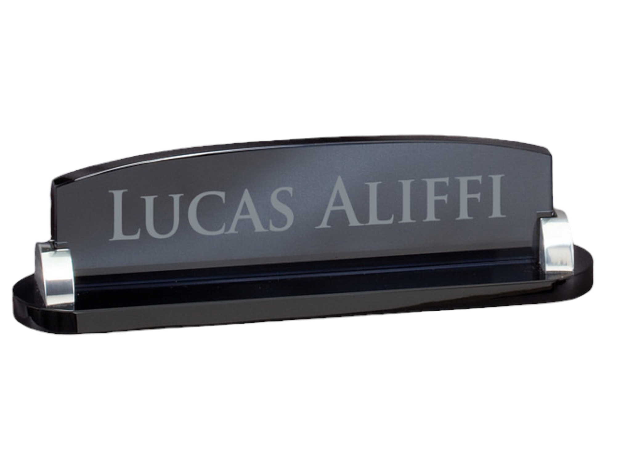 Our smoked glass desk name plate on a completely white background. The name plate is 2.5" x 9.5" in size, weighs 1.6 lbs and is laser engraved with the name of Lucas Aliffi.