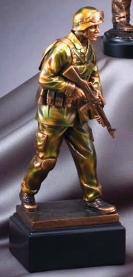Military solider statue in camouflage mounted on a black base, this is the side profile view.