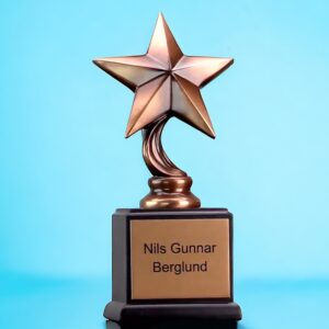 A military star trophy with a bronze colored star mounted on a black wood base. The base includes a bronze colored engraving plate that is personalized with black text.