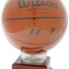 A basketball display case that features an acrylic top that holds a men's size basketball. It's mounted on a wood base that includes an engraving plate for personalization.