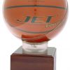 A basketball display case with an acrylic ball holder at the top. It holds a men's regulation 29.5 basketball. It's mounted on a larger wood base that includes a large engraving plate for extra personalization such as a team logo, text & other information.