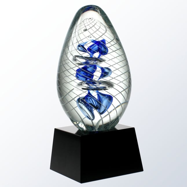 A glass egg with a blue with swirling lines, dancing bubbles and twisted blue colors on the inside. It's mounted on a black glass base that is blank, but normally it's personalized with text and/or a logo for an engraved award. 
