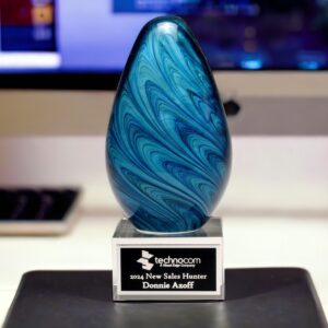 Our Blue Marble Glass Egg features a glass egg with blue marble swirls for an eye catching design. It's mounted on a clear glass base with a black & silver engraving plate that is personalized with a company logo and name of the winner of the award.