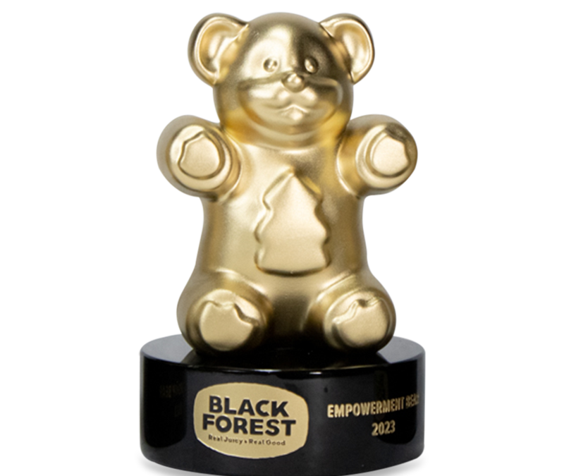 A trophy made from a giant gold gummy bear that is mounted on a black base. The base is personalized with a laser engraved logo & text.