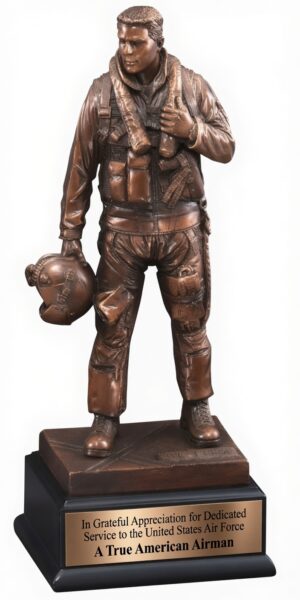 A realistic bronze statue of a United States Air Force airman in full flight gear, standing proudly on a black marble-style base. The detailed figure wears a flight suit with tactical vest, holds a helmet in one hand, and has a serious expression while looking forward. A polished bronze engraving plate on the front of the base reads: 'In Grateful Appreciation for Dedicated Service to the United States Air Force / A True American Airman'. This is the official Air Force Trophy (model RFB133), an 11.5-inch tall electroplated resin award honoring years of military service.