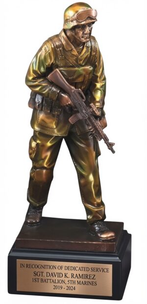 Camouflage Soldier Statue RFB063 featuring a highly detailed resin soldier in full camouflage uniform and tactical gear, holding a rifle in a ready stance. The 12.5-inch tall statue stands on a black base with a full-width bronze engraving plate that reads: 'IN RECOGNITION OF DEDICATED SERVICE, SGT. DAVID K. RAMIREZ, 1ST BATTALION, 5TH MARINES, 2019 - 2024' in black lettering. This personalized military award honors service and commitment.