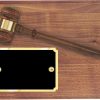 A genuine walnut board that has a walnut gavel at the top and a black & gold engraving plate in the bottom left hand corner. The engraving plate has gold names for added decoration on each side.