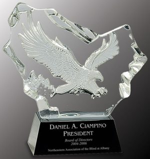 Clear crystal with eagle carved into the middle, mounted on black crystal base, CRY045 is 6" x 7" Size, Weighs 6 lbs.