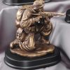 Solider shooting military statue shows soldier aiming gun mounted on black base, MIL203 is 5" x 9" Size, Weighs 4.75lbs.