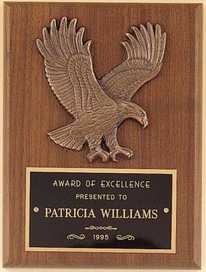 An eagle plaque made with a 6" x 8" walnut board, antique bronze eagle casting and a black & gold engraving plate for personalization.