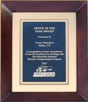 A cherry frame with a gold metal inside boarded and a blue marble sapphire engraving plate. It has gold engraving with text and a logo.
