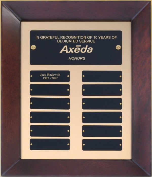 A cherry wood frame with a gold metal inside boarder. At the top is a main header plate with the company's logo. Underneath are 12 individual engraving plates, one showing engraving of someone's name.