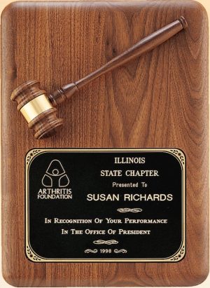 A large American walnut board that is 11x15 in size. It features a walnut gavel at the top and a black engraving plate at the bottom. The engraving plate has words of recognition for the President of Illinois State Chapter of the Arthritis Foundation.