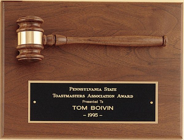 A 9x12 American walnut board with a walnut gavel mounted across the top half. The bottom half features a black & gold engraving plate that features words of recognition for the Pennsylvania State Toastmasters Association Award.