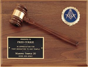 A solid American walnut wood board. On the walnut plaque is a walnut gavel, black engraving plate & an activity insert. The activity insert on this photo features the Freemason logo.