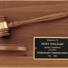 A walnut board with a walnut gavel & sounding block as decoration. In the bottom right hand corner is a black brass engraving plate with words of appreciation for a board chairman.