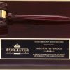 A 9x12 piano finished rosewood board with a rosewood gavel & black brass engraving plate. The gavel is also piano finished and has a gold gavel band. The black brass engraving plate engraves gold and features gold text & a company logo.