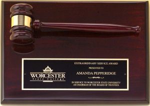 A 9x12 piano finished rosewood board with a rosewood gavel & black brass engraving plate. The gavel is also piano finished and has a gold gavel band. The black brass engraving plate engraves gold and features gold text & a company logo.