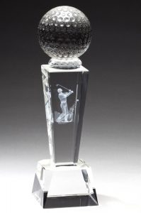 A Crystal trophy with a solid crystal golf ball at the top, a middle section with a laser engraved golfer in the middle of his swing & a clear crystal base at the bottom.