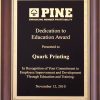 An award plaque with a cherry board and a black & gold engraving plate with a Florentine border. The gold engraving on the plate features a company logo and words of appreciation for an employee.