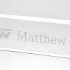 Our Crystal Name Plate features a rectangle piece of 3/4" thick clear crystal. This C1040 crystal nameplate measures 2.25" x 12" in size and weighs 2.6 lbs. This particular name plate is laser engraved with a company logo on the left for Keihin Corporation and Matthew Stevens name to the right of it.