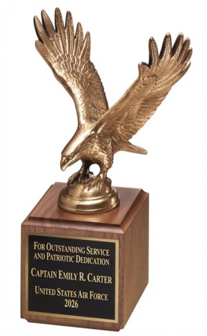 1293 XL Eagle Statue featuring a detailed antique bronze-finished eagle with wings majestically outstretched, mounted on a polished walnut wood base with a black engraving plate. The plate is gold laser-engraved with: 'FOR OUTSTANDING SERVICE AND PATRIOTIC DEDICATION / Captain Emily R. Carter / United States Air Force / 2026'. This 9″ tall (3.5″ x 10.75″, 5 lbs) patriotic military recognition award.