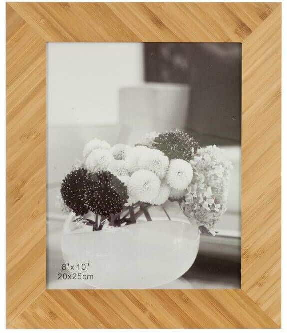 A bamboo picture frame that holds an 8x10 photo. The photo is just a black & white stock photo of flowers. There is no engraving on this picture frame.
