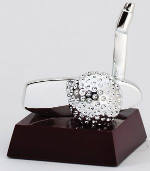 A golf trophy featuring a silver putter head & silver golf ball mounted on a dark wood base.