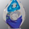 Glass art award with unique shape & hues of blue colors, mounted on clear glass base, AGS01 is 8" tall, Weighs 4 lbs.