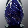 Egg shaped piece of glass with dark blue swirl throughout, Mounted on black glass base, AGS17, 6.75" tall