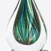 Green teardrop art glass mounted on a black glass base, glsc44, 7" tall, weighs 2.3 lbs