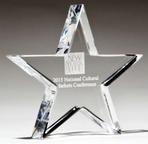A 4" x 4" Crystal Star Paperweight made form 7/8" thick crystal. It has a logo for the New York Life company laser engraved in the back of it for decoration.