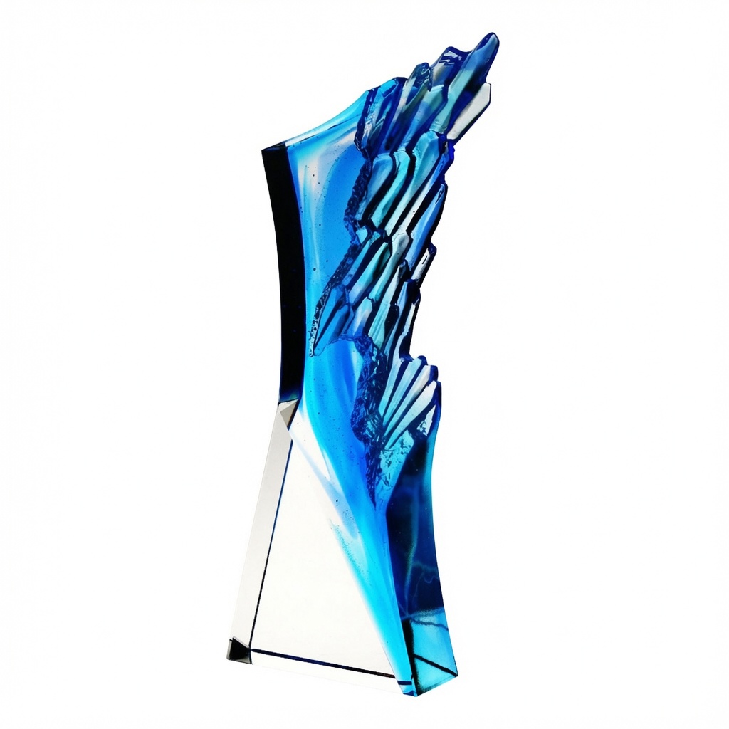 Blue Crest Crystal Award (C2463) – a striking handcrafted optic crystal trophy featuring vibrant blue pâte de verre accents that resemble a dynamic coastal wave or arctic crest. This modern, self-standing 10-1/8 inch tall premium recognition piece showcases beautiful light refraction and a sleek clear crystal base, ideal for custom laser engraving. Presented on a pure white background.