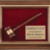 A genuine walnut frame with a gold inlay. Inside the frame is a maroon velour background with a walnut gavel & gold engraving plate on top. The gold engraving plate is recognition for a Chairman's Club Award.