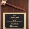 A 9x12 walnut board with a walnut gavel & a gold gavel band at the top. At the bottom is a black engraving plate with a gold backer. The engraving is recognition for the Chair of the Board for the AAMVA.