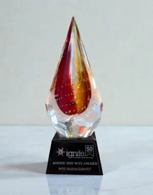 Our Red Flare Glass Art Award features strong colors of red & orange together within this spear shaped glass piece that is mounted on a black glass base with an engraving plate for personalization. The G1611 is 3.5" by 4" by 9.75". This photo shows the front of the item.