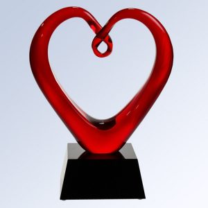 Glass heart with red colored glass, mounted on a black glass base, G1610 is 9" tall, weighs 5.2 lbs.