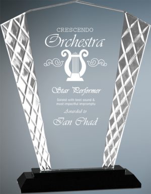 A glass award made in the shape of a hand fan with a stainless steel diamond cut design on the sides. The inside features laser engraving for the Star Performater of the Crescendo Orchestra. That clear glass piece is mounted on a black glass base.