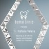 A glass award in the shape of a diamond. The edges are accented with a stainless steel diamond cut for decoration. The inside has laser engraving for a dentist for her dedication to customers. It's mounted on a black glass base.