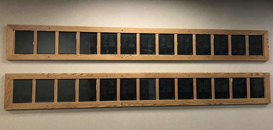 A look at how Owens-Illinois displays their patents. It shows glass plaques with the patents laser engraved directly onto them and placed into their custom woodwork.