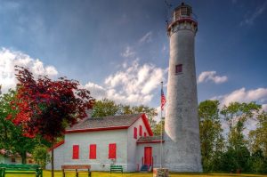 Here's a photo of a white lighthouse with red accents.