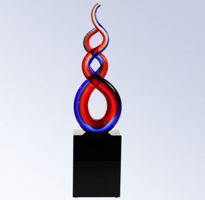 An art glass red, white & clear double glass helix mounted on a black glass base. The base is blank, but traditionally a logo and/or text is added to personalize the award.
