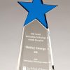 A crystal trophy with a blue crystal star at the top and clear crystal below that has laser engraving personalization on it. The clear crystal gets wider at the bottom so it can stand freely without falling over.