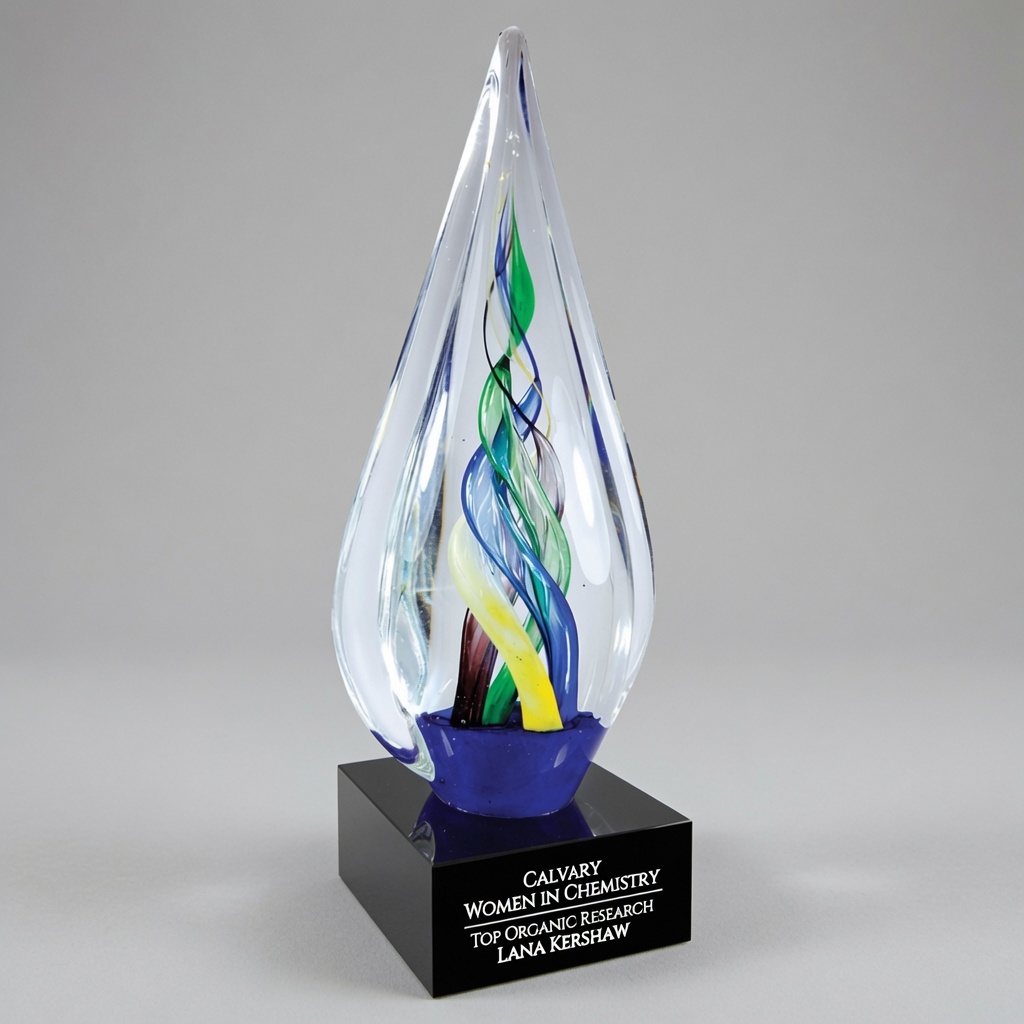 The award features a tall, elegant teardrop-shaped clear hand-blown art glass sculpture with a smooth, polished surface. Inside the crystal, vibrant multicolored glass ribbons in shades of blue, green, yellow, and purple twist gracefully upward in a dynamic spiral pattern, creating a sense of continuous motion. The glass piece is mounted on a solid black square base. The trophy is shown from a straight frontal view against a clean green studio background with even lighting that highlights the transparency of the crystal and the vivid internal colors.