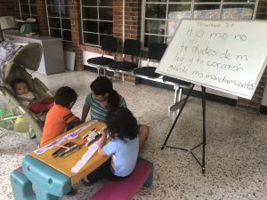 This is a photo of Sunday School for the children of El Refugio. The white board reads:  Proverbs 3:1 “My son, do not forget my teaching, but let your heart keep my commandments”