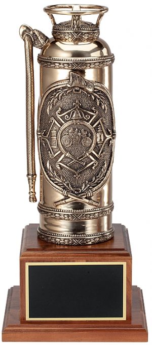 An antique bronze fire extinguisher with extreme detail design. The design in the middle features a firefighter Maltese cross with a classic firefighter steamer in the middle. It's mounted on a walnut base with a black brass engraving plate for personalization.