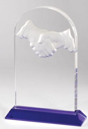 Domed crystal award with a deep etched handshake at the top & a blue base at the bottom.