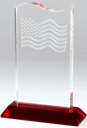 Clear crystal piece with an etched American flag at the top with an empty engraving area below. It's all mounted on a red crystal base.