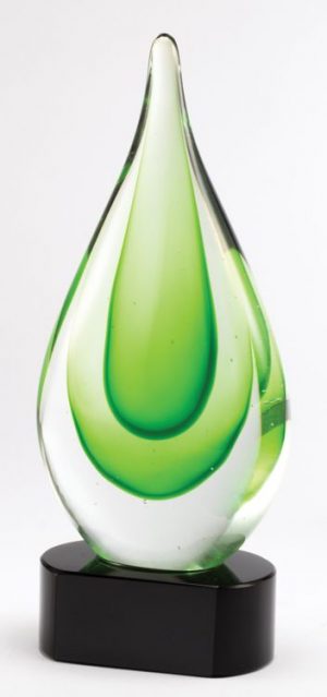 Glass rain drop with multiple shades of green throughout mounted on a black glass base.