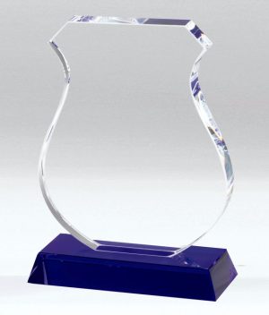 Crystal award in the shape of a police badge mounted on a blue crystal base.